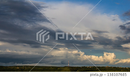 Dramatic cloud formations over a rural landscape during late afternoon with varying shades of gray and blue skies 138107685