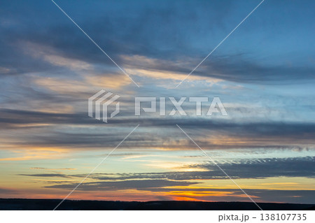 Dramatic sunset sky with vibrant clouds and soft light illuminating the horizon during twilight Dramatic sunset sky with vibrant clouds and soft light illuminating the horizon during twilight 138107735