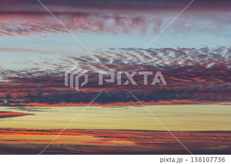 Vibrant sunset colors fill the sky with hues of red orange and purple over a tranquil horizon during late evening hours Vibrant sunset colors fill the sky with hues of red orange and purple over a tranquil horizon during late evening hours 138107736