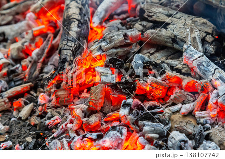 Coal embers glowing intensely in a fireplace at night creating a warm and inviting atmosphere for gathering and relaxation Coal embers glowing intensely in a fireplace at night creating a warm and inviting atmosphere for gathering and relaxation 138107742