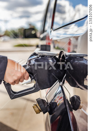 Fueling car at gas station closeup with hand holding nozzle  138107806