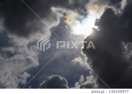 Dark clouds part to reveal bright sun Dark clouds part to reveal bright sun 138108977