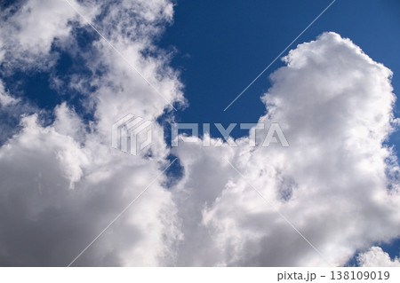 Clouds drift across vivid blue sky 138109019