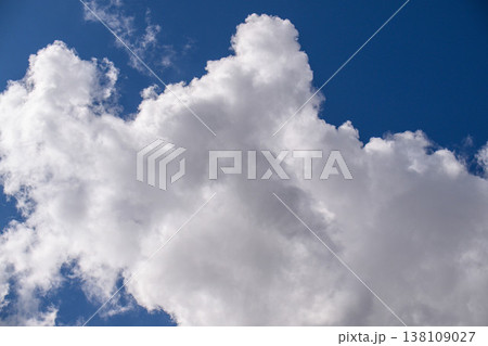 Calm, dramatic sky with voluminous cumulus cloud against clear blue 138109027