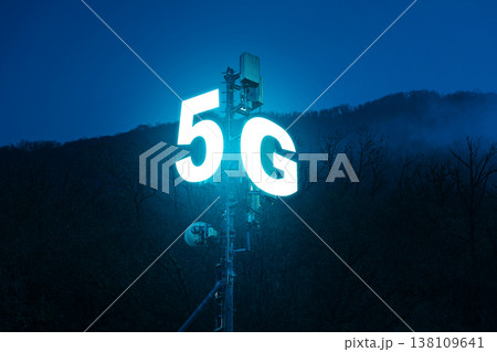 Bright 5G sign glowing at night near mountain area signaling fast internet service access Bright 5G sign glowing at night near mountain area signaling fast internet service access 138109641