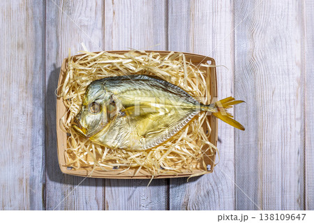 Smoked fish in a plate with sawdust, top view 138109647