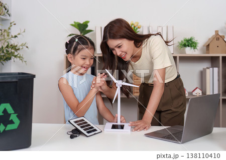 Mother and daughter exploring wind energy at home Mother and daughter exploring wind energy at home 138110410