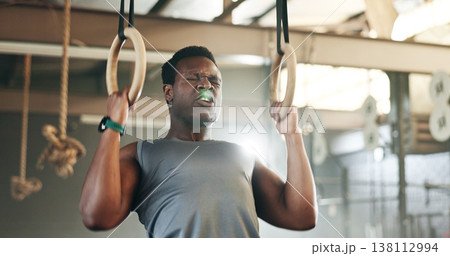 Sports, gymnastics and black man doing pull up exercise for arm muscle training or workout in gym. Fitness, bodybuilding and African male athlete doing an intense strength challenge in health center. Sports, gymnastics and black man doing pull up exercise for arm muscle training or workout in gym. Fitness, bodybuilding and African male athlete doing an intense strength challenge in health center. 138112994