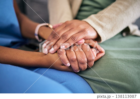 Hands, empathy and helping with life crisis, caregiver with patient for support and grief counseling. People sitting together, healthcare and wellness with advice, kindness and respect with trust 138113087