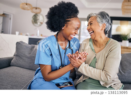 Smile, funny and assisted living caregiver with an old woman in her home during retirement together. Healthcare, support and a happy nurse or volunteer laughing with a senior patient on the sofa 138113095