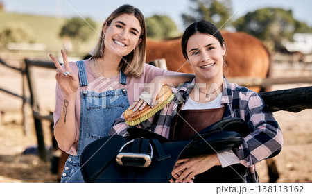 Horse, peace sign and portrait of women with saddle and brush for animal care, pet and happy on ranch. Farming friends, countryside and people with stallion for bonding, relax and adventure outdoors 138113162