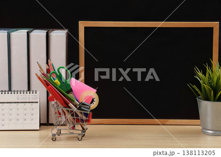 Classroom desk with blackboard and stationery in shopping cart 138113205