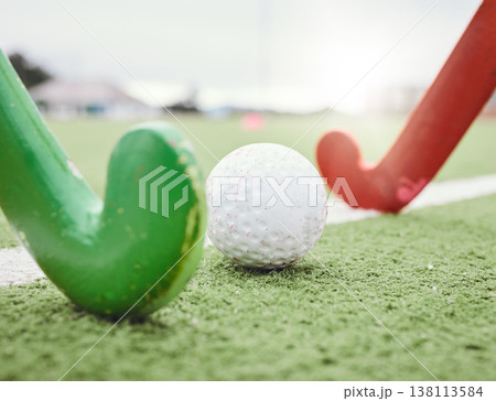 Hockey, game and stick with ball on green, field or pitch with sports equipment in competition, match ground or floor. Artificial grass, turf or training with gear in sport, tournament or stadium 138113584