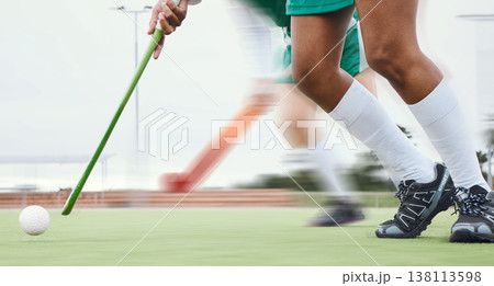 Person, feet and hockey stick on field, ball with speed or motion for sports goal, training or professional game. Action, legs and turf with performance for outdoor competition, fitness and exercise Person, feet and hockey stick on field, ball with speed or motion for sports goal, training or professional game. Action, legs and turf with performance for outdoor competition, fitness and exercise 138113598