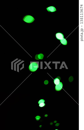 Bokeh, green dots and lights on black background with pattern, texture and mockup with cosmic aesthetic. Night lighting, sparkle particles and glow on dark wallpaper with space, color shine and flare Bokeh, green dots and lights on black background with pattern, texture and mockup with cosmic aesthetic. Night lighting, sparkle particles and glow on dark wallpaper with space, color shine and flare 138113674