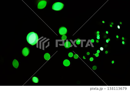 Green light, bokeh and glow on dark background isolated on a mockup space. Blur, black backdrop and defocused shine, sparkle or glitter at night for Christmas, holiday or party with magic color dots Green light, bokeh and glow on dark background isolated on a mockup space. Blur, black backdrop and defocused shine, sparkle or glitter at night for Christmas, holiday or party with magic color dots 138113679