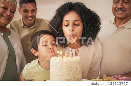 Happy birthday, big family and child with cake blowing candle in a home for event to celebrate together in a house. Grandparents, happiness and kid excited for gathering, surprise and gift 138113737