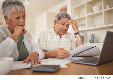 Debt, stress and senior couple with financial, bills and budget at computer with paperwork. Anxiety, banking problem and savings planning for pension and retirement in a home with web tax notes 138113802