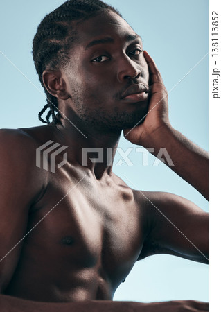 Black man, beauty with grooming and face, shirtless in studio and isolated on blue background. Hygiene, skincare and African model with muscle, clean dermatology and natural cosmetics in portrait 138113852