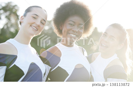 Cheerleader, happy and portrait of women for performance, dance and motivation for game. Teamwork, dancer and people in costume cheer for support in match, competition and sports event outdoors 138113872