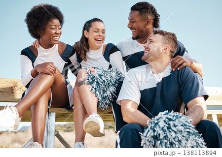 Cheerleader, sports and people laugh on bench for performance, dance and motivation for game. Teamwork, dancer and people laugh in costume for support in match, competition and field event outdoors 138113894