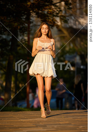 Slavic Woman Walking in Warm Golden Light 138114980