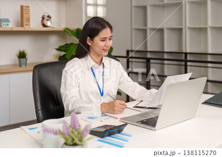 Accountant working on financial reports at desk Accountant working on financial reports at desk 138115270