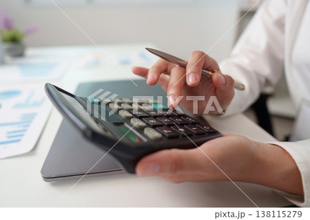 Accountant using calculator for financial calculations Accountant using calculator for financial calculations 138115279
