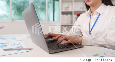 Close-up of accountant typing on laptop in office environment Close-up of accountant typing on laptop in office environment 138115323