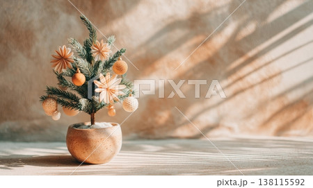 A small potted Christmas tree is decorated with wooden and paper ornaments. Natural simplicity and cozy holiday warmth. 138115592