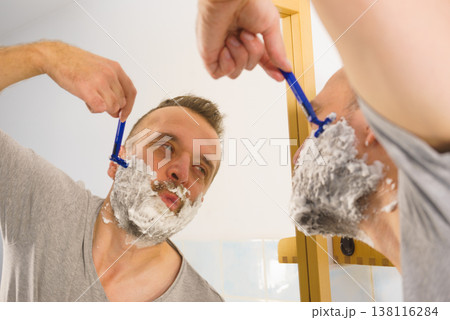 Guy shaving his beard in bathroom 138116284