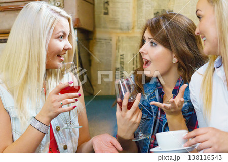 Women gossiping in pub 138116543