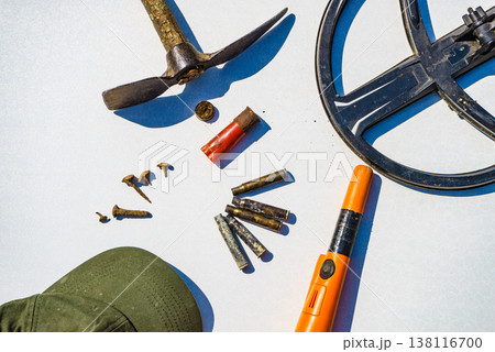 Metal detecting equipment gear and found items displayed on a white surface. Hobby and activity Metal detecting equipment gear and found items displayed on a white surface. Hobby and activity 138116700