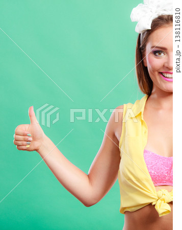 Happy pretty pin up girl showing thumb up gesture. 138116810