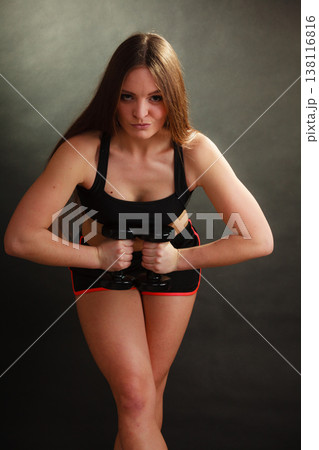 Fit woman exercising with dumbbells. Fit woman exercising with dumbbells. 138116816