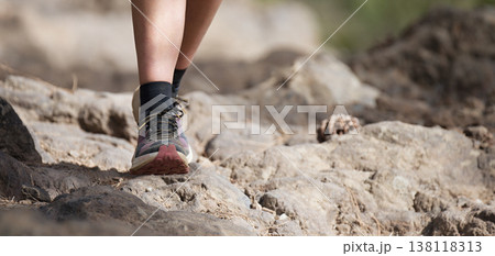 Walking or running exercise legs on rocky footpath in bright forest achievement fitness adventure and exercising in spring or summer nature motivation and inspirational activity 138118313