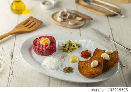 Steak tartare dish with egg yolk and ingredients Steak tartare dish with egg yolk and ingredients 138119198