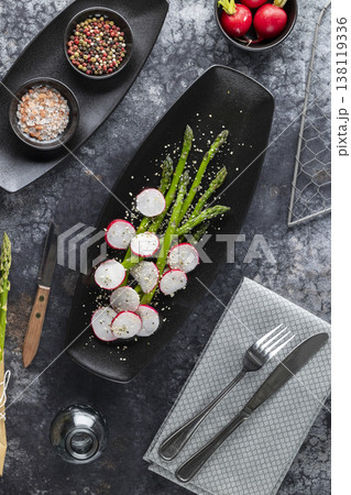 Asparagus and radish salad on black plate Asparagus and radish salad on black plate 138119336
