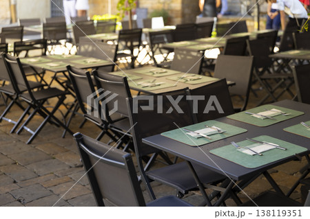 Empty outdoor restaurant tables ready for al fresco dining Empty outdoor restaurant tables ready for al fresco dining 138119351