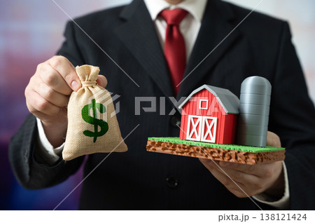 A businessman owns a farm and has a dollar in his pocket. Buying and selling a farm. Investing in agribusiness. Farmer income, paying taxes. Agricultural assets and rural economy growth 138121424