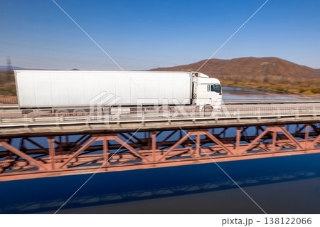 White truck on a bridge over the river White truck on a bridge over the river 138122066