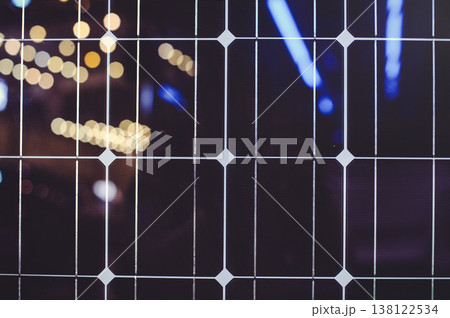 A horizontal macro top-down view of the repetitive pattern of solar cells. The image shows the dark blue silicon surface and the thin silver conductive grid. A horizontal macro top-down view of the repetitive pattern of solar cells. The image shows the dark blue silicon surface and the thin silver conductive grid. 138122534