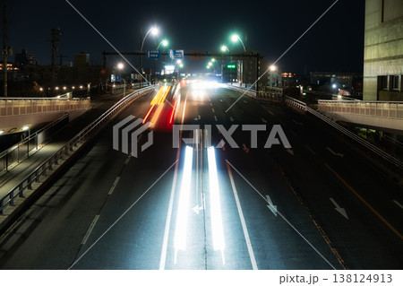夜の幹線道路を駆け抜ける自動車の光跡と都市風景 夜の幹線道路を駆け抜ける自動車の光跡と都市風景 138124913