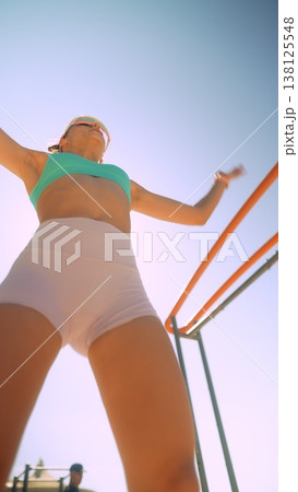 Female athlete exudes confidence during seaside workout session 138125548