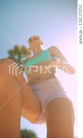 Powerful female athlete midstride in bright environment Powerful female athlete midstride in bright environment 138125552