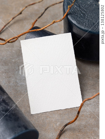 Blank card mockup on grey stone with dry branches and candles. Minimal stationery template 138125802
