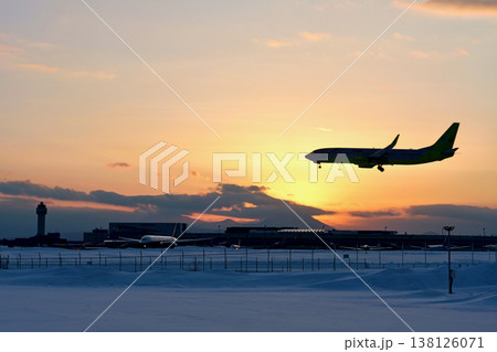 「冬の新千歳空港」夕焼けをバックに着陸する機影 「冬の新千歳空港」夕焼けをバックに着陸する機影 138126071