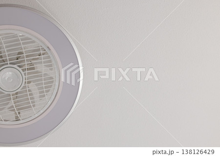 A lamp with fan on a white sailing. Closeup, copy space. A lamp with fan on a white sailing. Closeup, copy space. 138126429