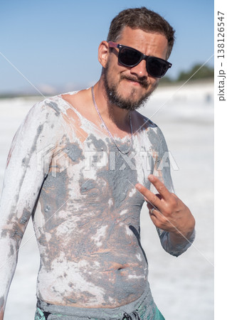 Man Enjoying Mud Therapy at a Natural Spa Location Under Bright Sunlight Man Enjoying Mud Therapy at a Natural Spa Location Under Bright Sunlight 138126547