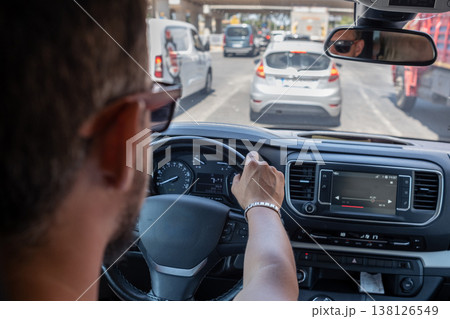 Driving in Busy City Traffic During the Day With Modern Cars and Urban Structures in the Background Driving in Busy City Traffic During the Day With Modern Cars and Urban Structures in the Background 138126549